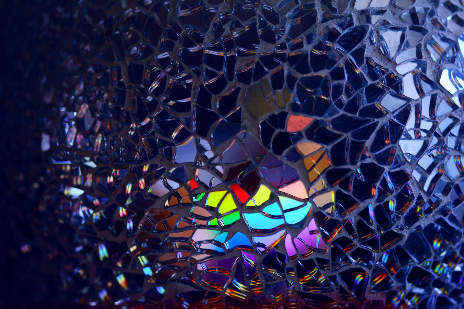 Moody editorial photograph of a cracked mirror reflecting fragmented abstract shapes, dimly lit studio setting, dramatic side lighting, conceptual visual metaphor for distorted self-image - Photo by okeykat on Unsplash - Photo by Alexander Grey on Unsplash