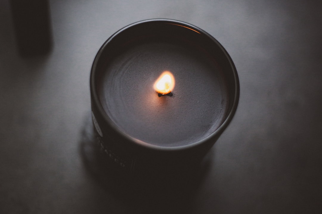 Overhead flat lay of a notebook open to a handwritten list, a pen beside it, soft rose petals scattered nearby, warm candlelight glow, intimate and playful creative mood, top-down angle - Photo by maar gaming on Unsplash