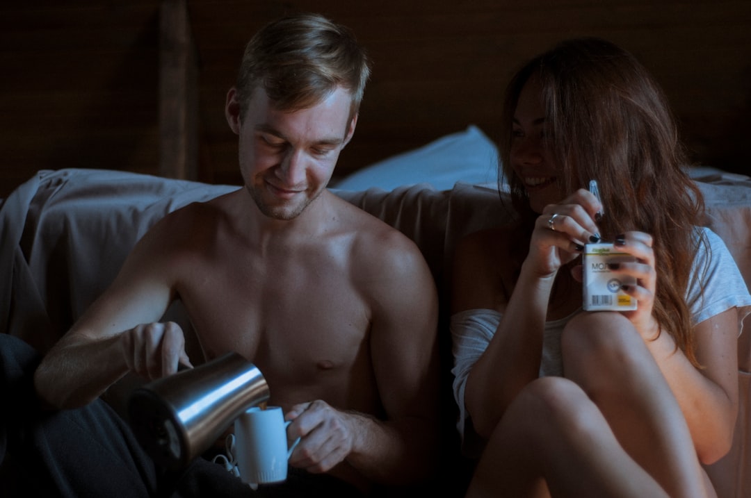 Soft-focus image of a morning coffee setup on a wooden bedside table, two mugs of coffee steaming, warm sunlight streaming through white curtains, calm and unhurried atmosphere, close-up shot - Photo by Pasha Chusovitin on Unsplash
